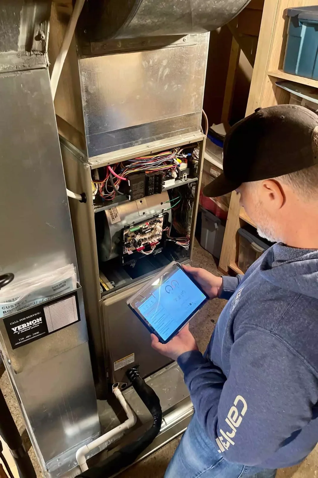 HVAC technician diagnosing a residential furnace