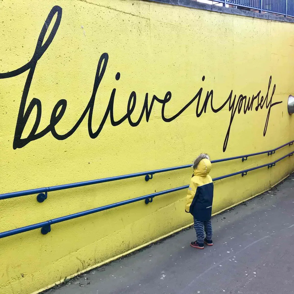 kid reading a sign about believing in yourself