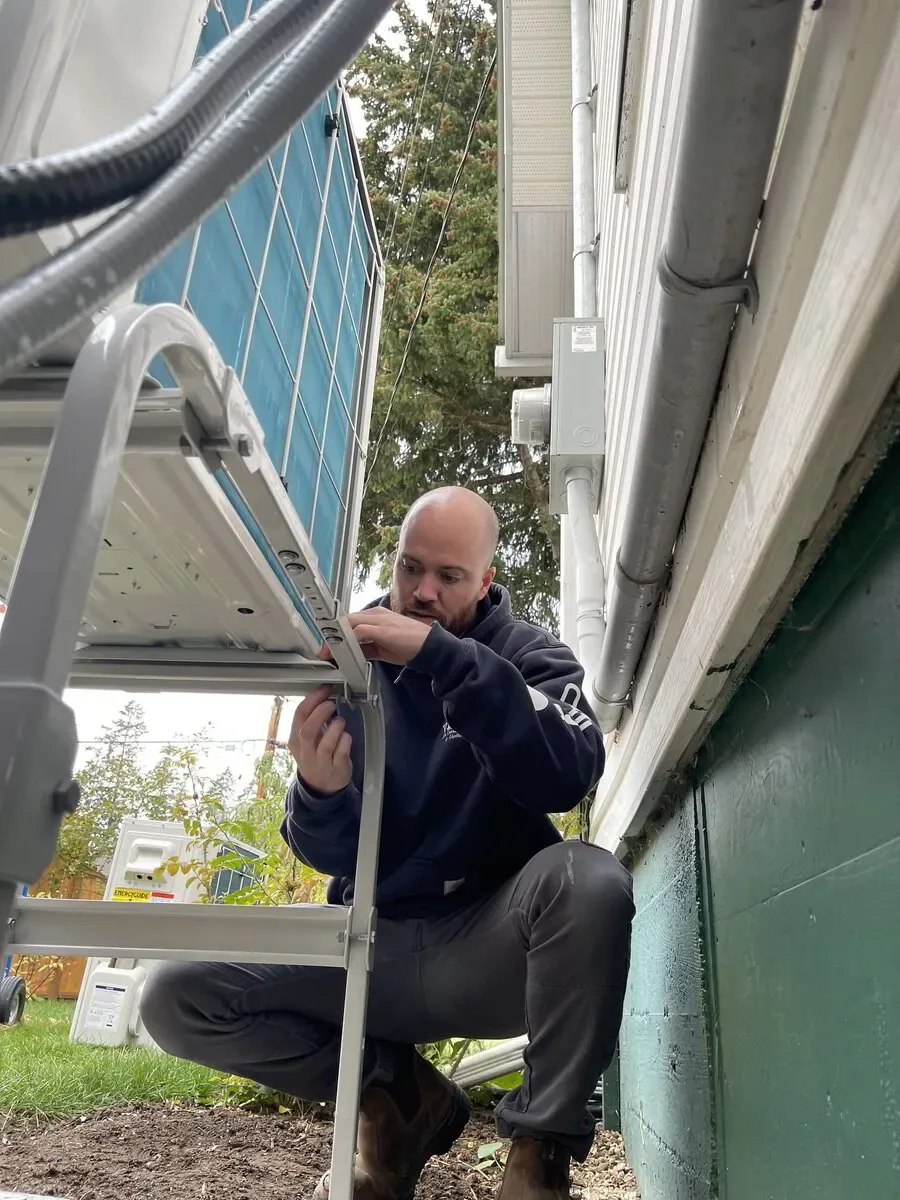 HVAC tech installing a ductless mini split outdoor unit