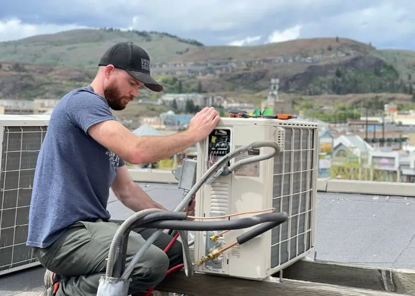 HVAC tech fixing a frozen AC line