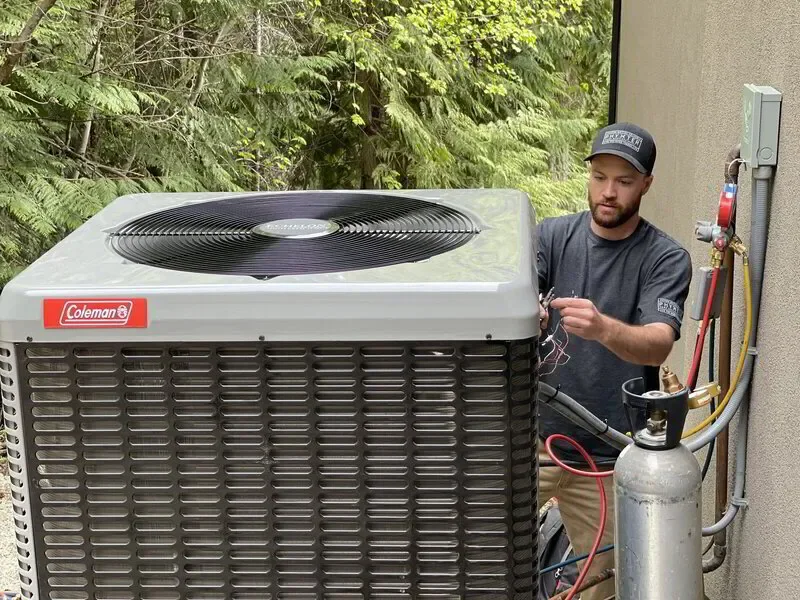 HVAC tech maintaining a heat pump