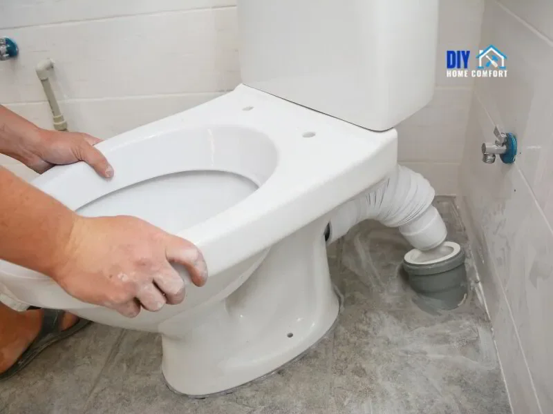 Plumber moving toilet to check wax ring