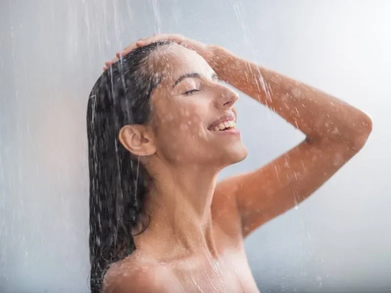 woman taking a shower in a basement bathroom